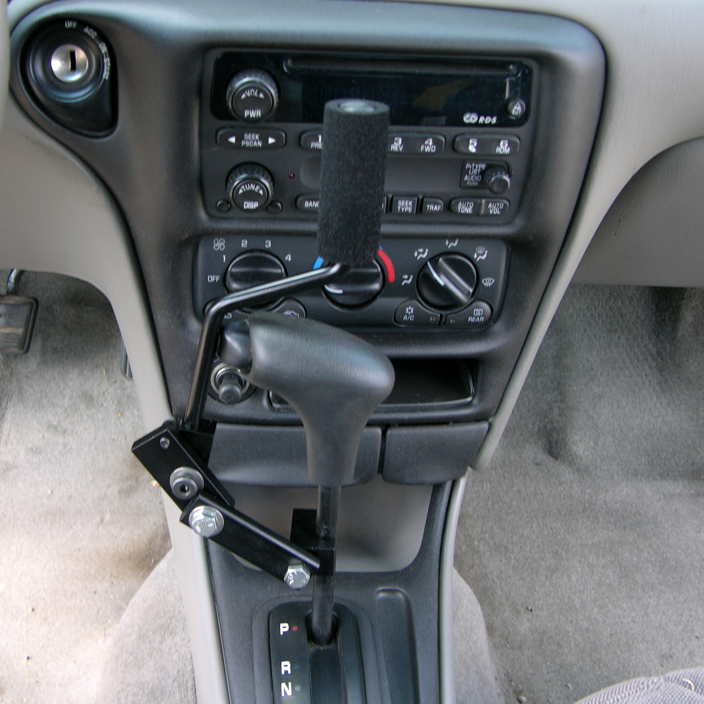 T-Handle Style Gear Shift Our T-Handle Style Gear Shift extension enables the driver to push in the gear shift button and move the gear shift lever in one easy motion.